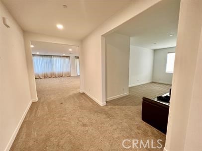 24800 Cimarron Circle Menifee, CA 92584 - Photo 5 of 29 an empty room with kitchen space and wooden floor