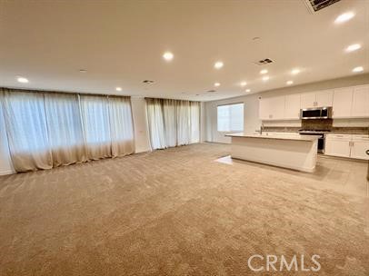 24800 Cimarron Circle Menifee, CA 92584 - Photo 7 of 29 a view of kitchen with stainless steel appliances wooden floor and large window