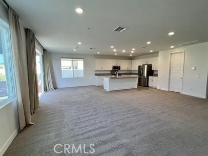 24800 Cimarron Circle Menifee, CA 92584 - Photo 8 of 29 a view of a kitchen with a sink and a refrigerator