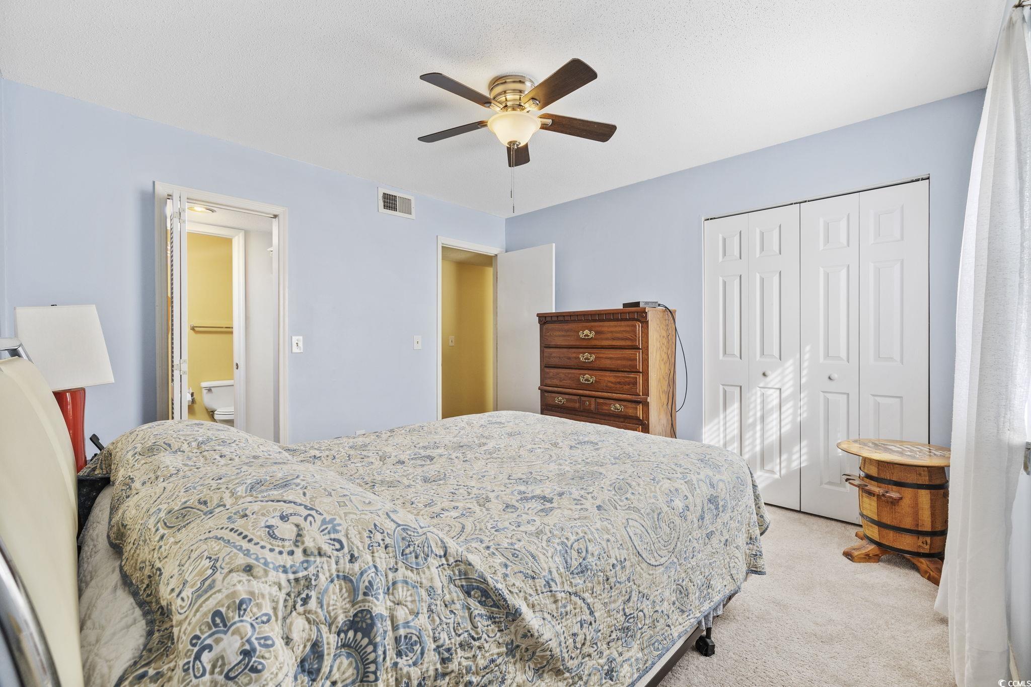 1356 Glenns Bay Road, Unit E 204 Surfside Beach, SC 29575 - Photo 15 of 27 Carpeted bedroom with a closet and ceiling fan