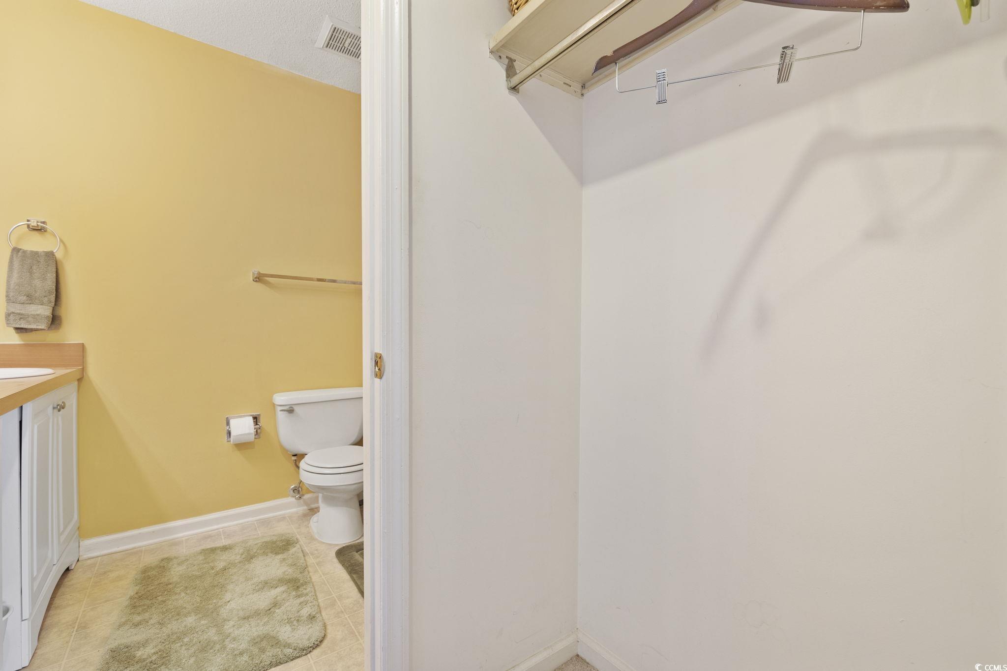 1356 Glenns Bay Road, Unit E 204 Surfside Beach, SC 29575 - Photo 16 of 27 Bathroom with vanity, a textured ceiling, and toil