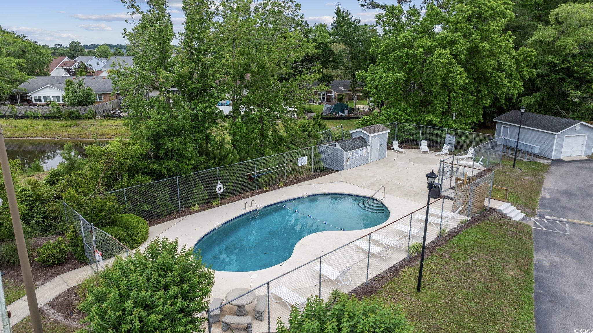 1356 Glenns Bay Road, Unit E 204 Surfside Beach, SC 29575 - Photo 25 of 27 View of pool featuring a patio