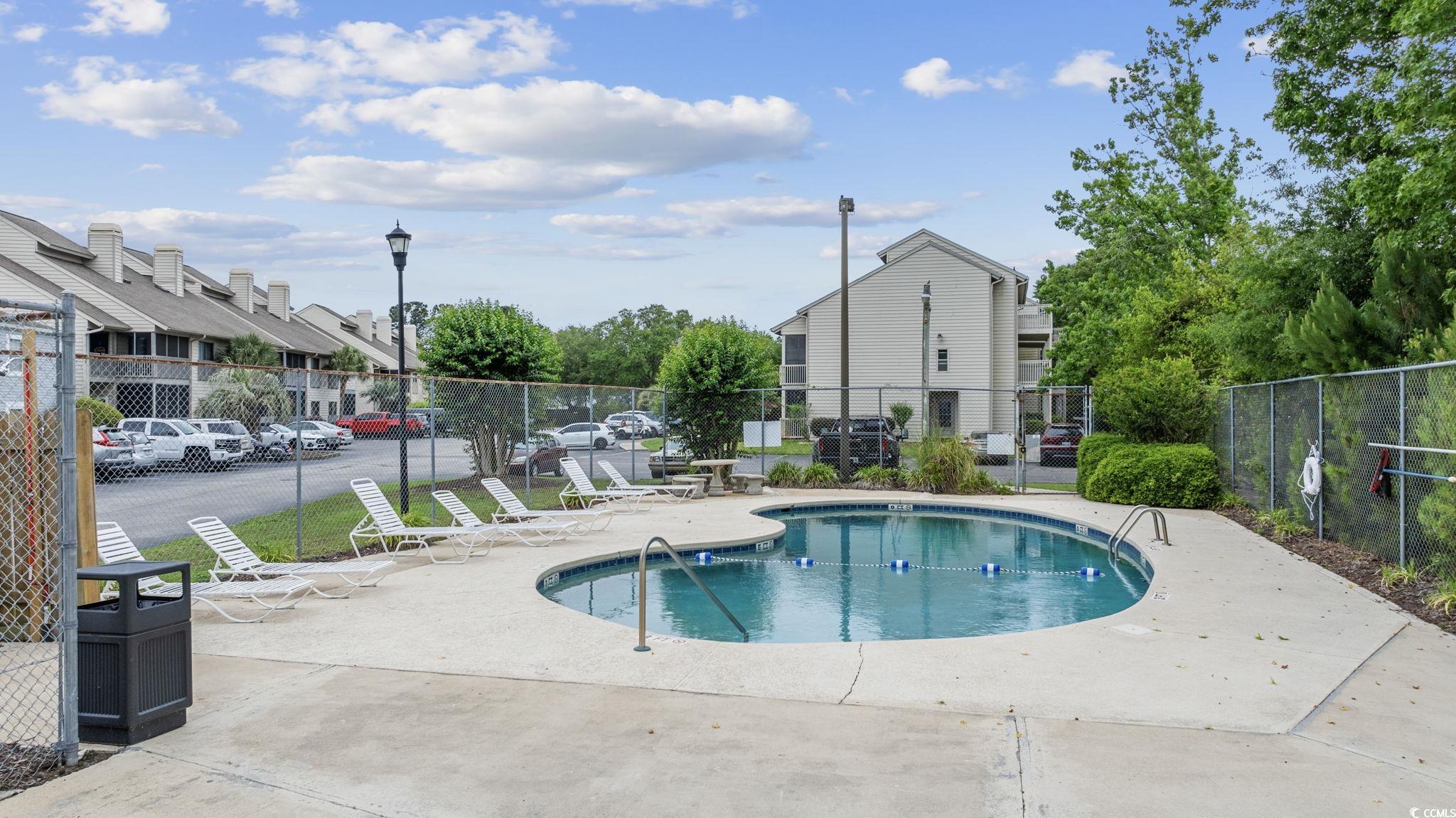1356 Glenns Bay Road, Unit E 204 Surfside Beach, SC 29575 - Photo 26 of 27 View of pool featuring a patio area