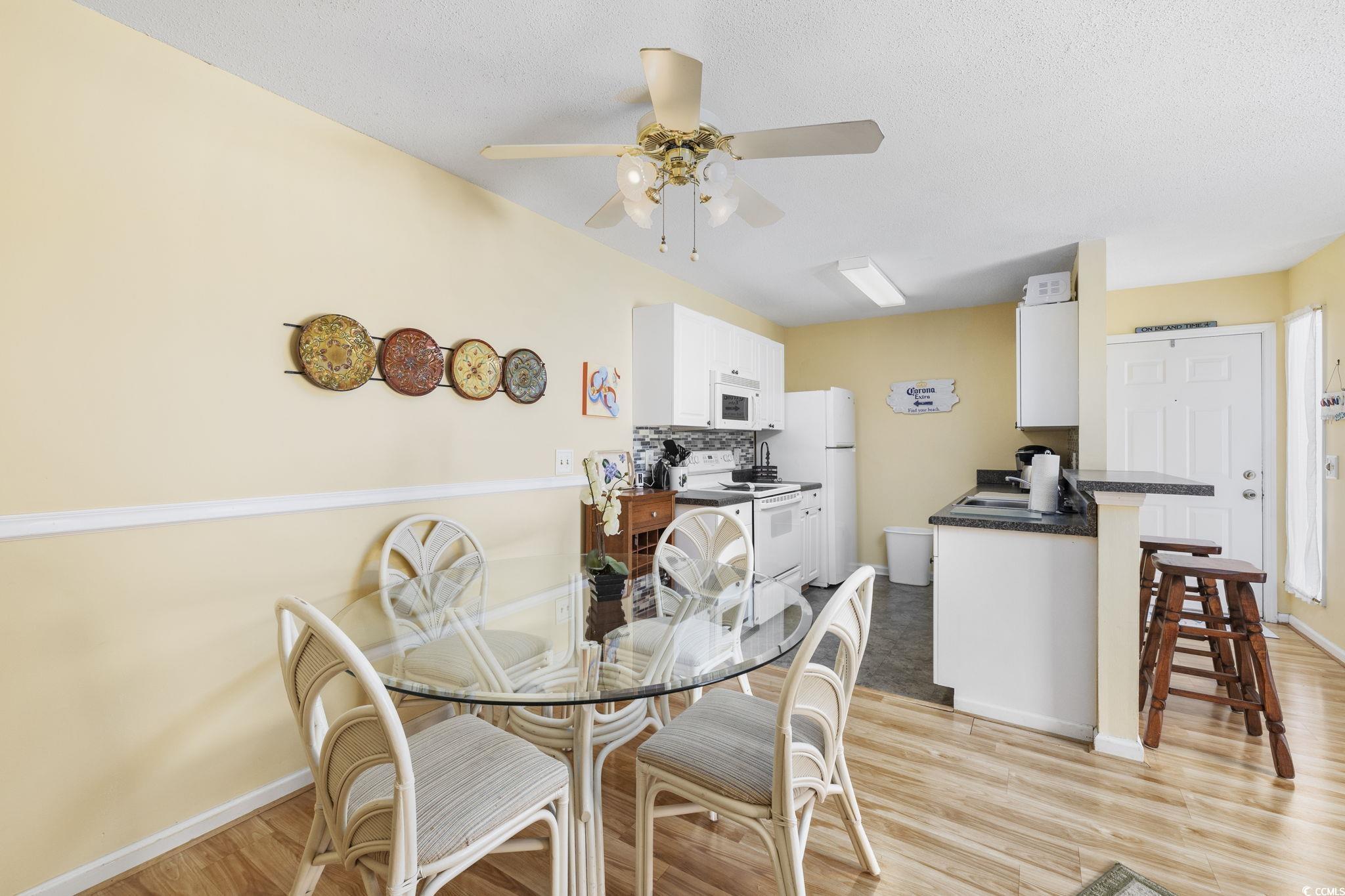 1356 Glenns Bay Road, Unit E 204 Surfside Beach, SC 29575 - Photo 8 of 27 Dining area featuring ceiling fan and light hardwo