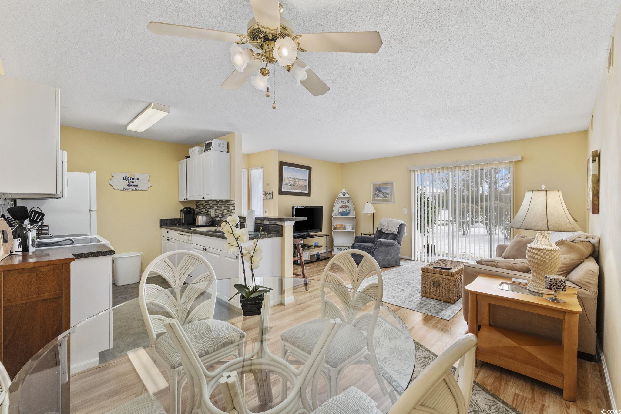 1356 Glenns Bay Road, Unit E 204 Surfside Beach, SC 29575 - Photo 9 of 27 Dining area with ceiling fan, light hardwood / woo