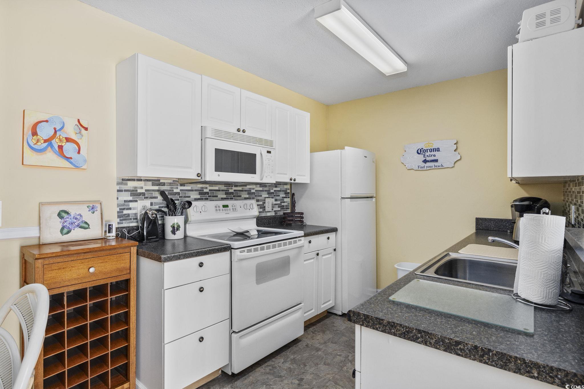 1356 Glenns Bay Road, Unit E 204 Surfside Beach, SC 29575 - Photo 10 of 27 Kitchen featuring white appliances, sink, decorati