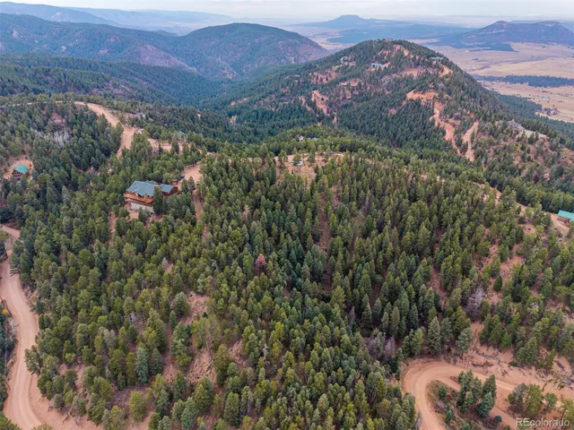 an aerial view of mountain with an outdoor space