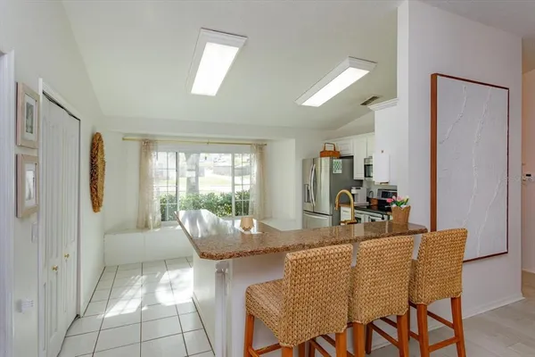 a dining room with furniture and window