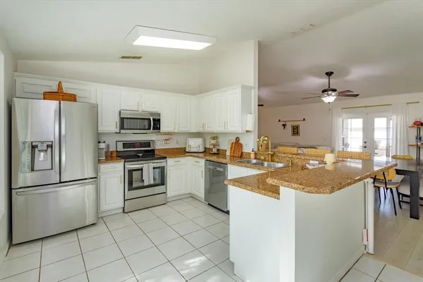 a kitchen with cabinets and stainless steel appliances