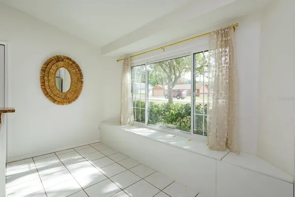 a view of a room with window and a large mirror