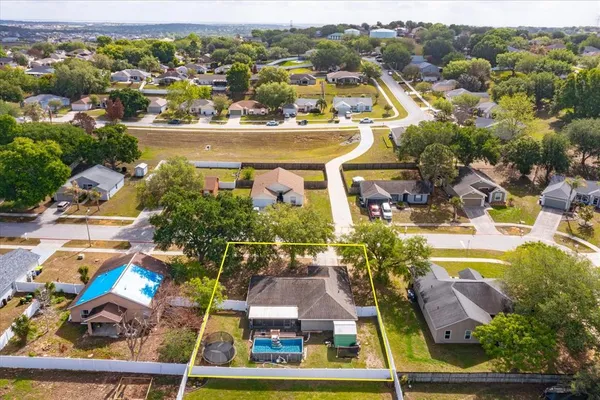 an aerial view of residential houses with outdoor space and swimming pool