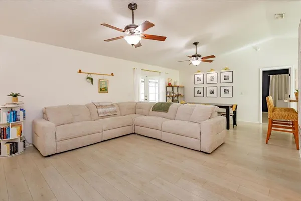 a living room with furniture and a chandelier