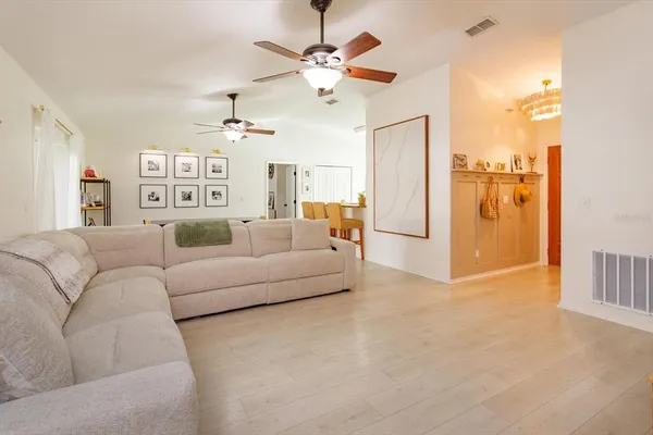 a living room with furniture and a chandelier