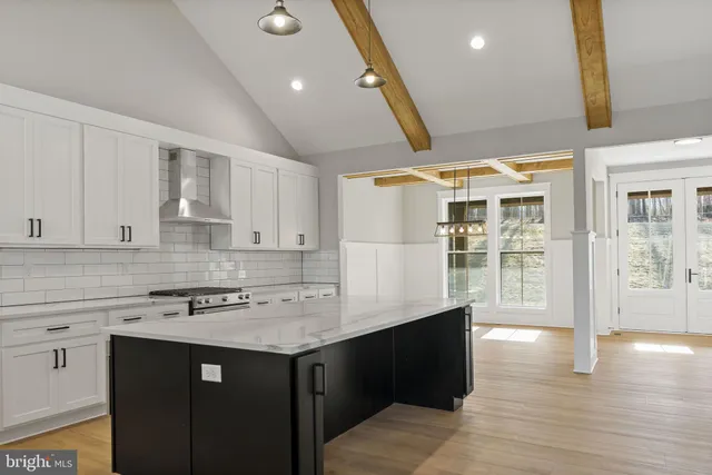 a kitchen with stainless steel appliances granite countertop a stove and a sink