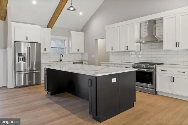 a kitchen with stainless steel appliances granite countertop a stove and a sink