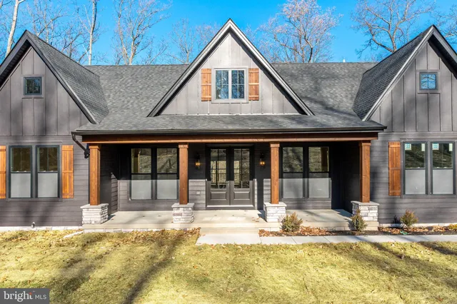 a kitchen with stainless steel appliances granite countertop a sink cabinets and wooden floor
