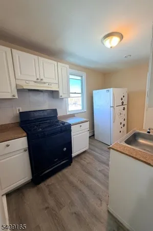 a kitchen with a stove and a refrigerator