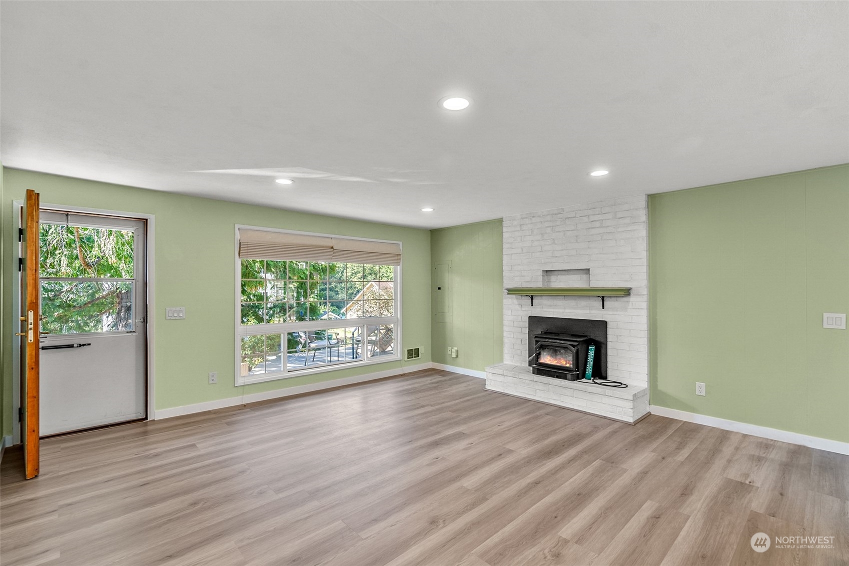 2725 Callow Road Lake Stevens, WA 98258 - Photo 3 of 37 a view of an empty room with wooden floor fireplace and a window