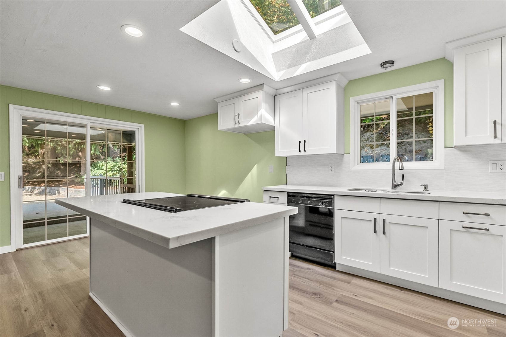 2725 Callow Road Lake Stevens, WA 98258 - Photo 8 of 37 a kitchen with granite countertop a sink and white cabinets with wooden floor