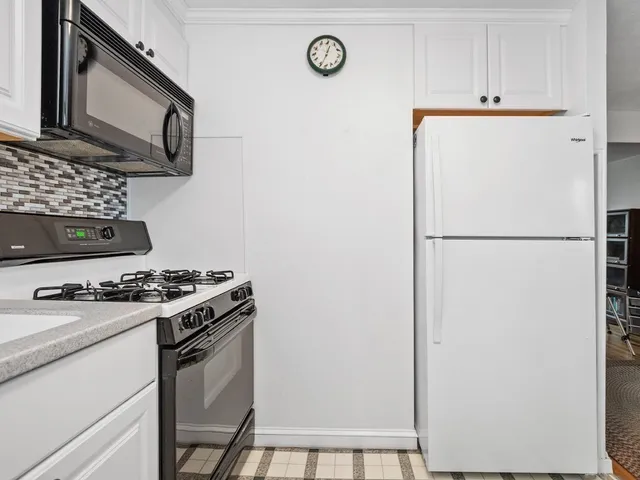 a kitchen with a stove and a refrigerator
