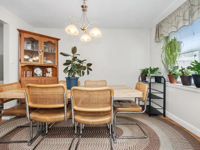 a dining room with furniture and chandelier