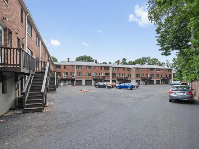 a view of city street with a car parked on the road