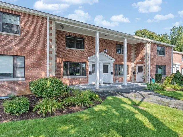 a front view of a house with a yard and porch