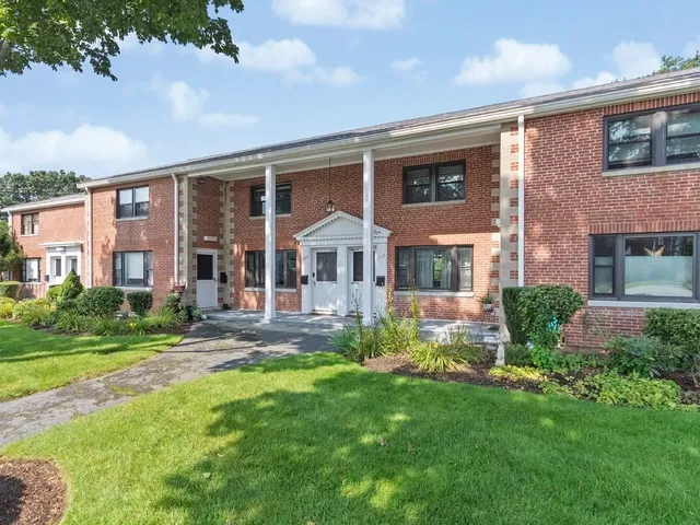 a view of a house with a yard and plants