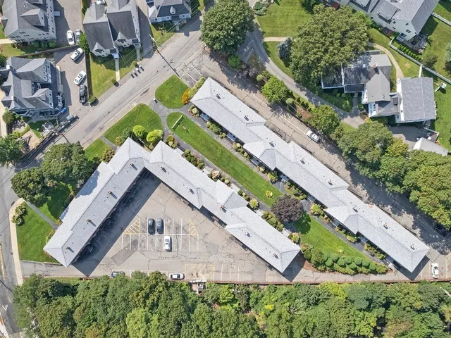 an aerial view of a house with a yard