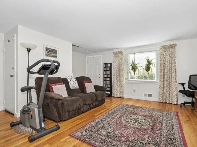 a living room with furniture rug and window
