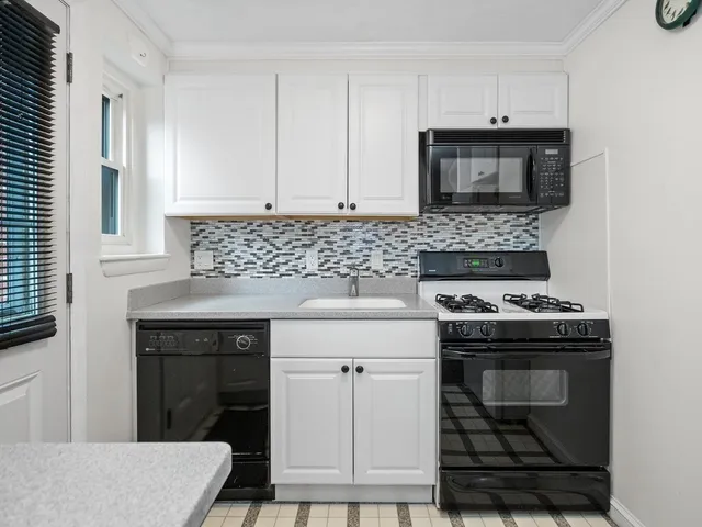 a kitchen with granite countertop a stove and a sink