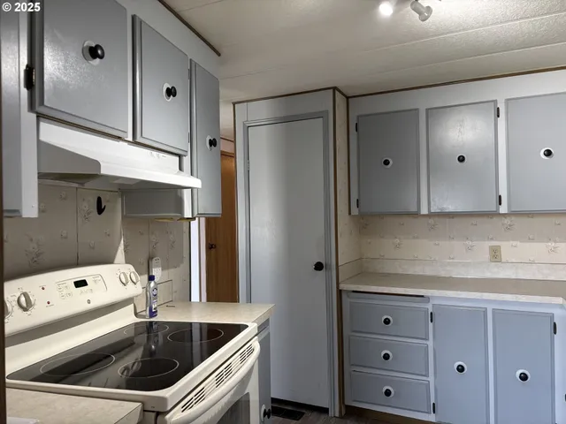 a kitchen with a refrigerator and a sink