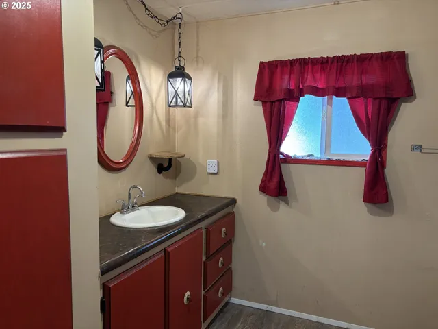a bathroom with a sink vanity and mirror