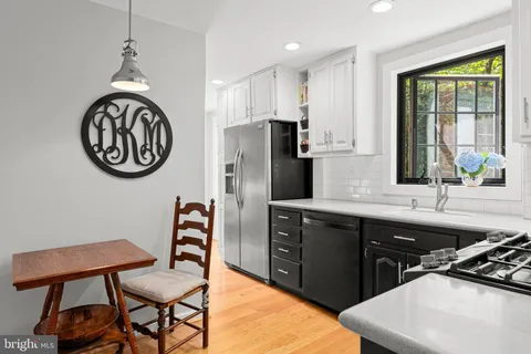 a kitchen with stainless steel appliances a sink a stove and a refrigerator