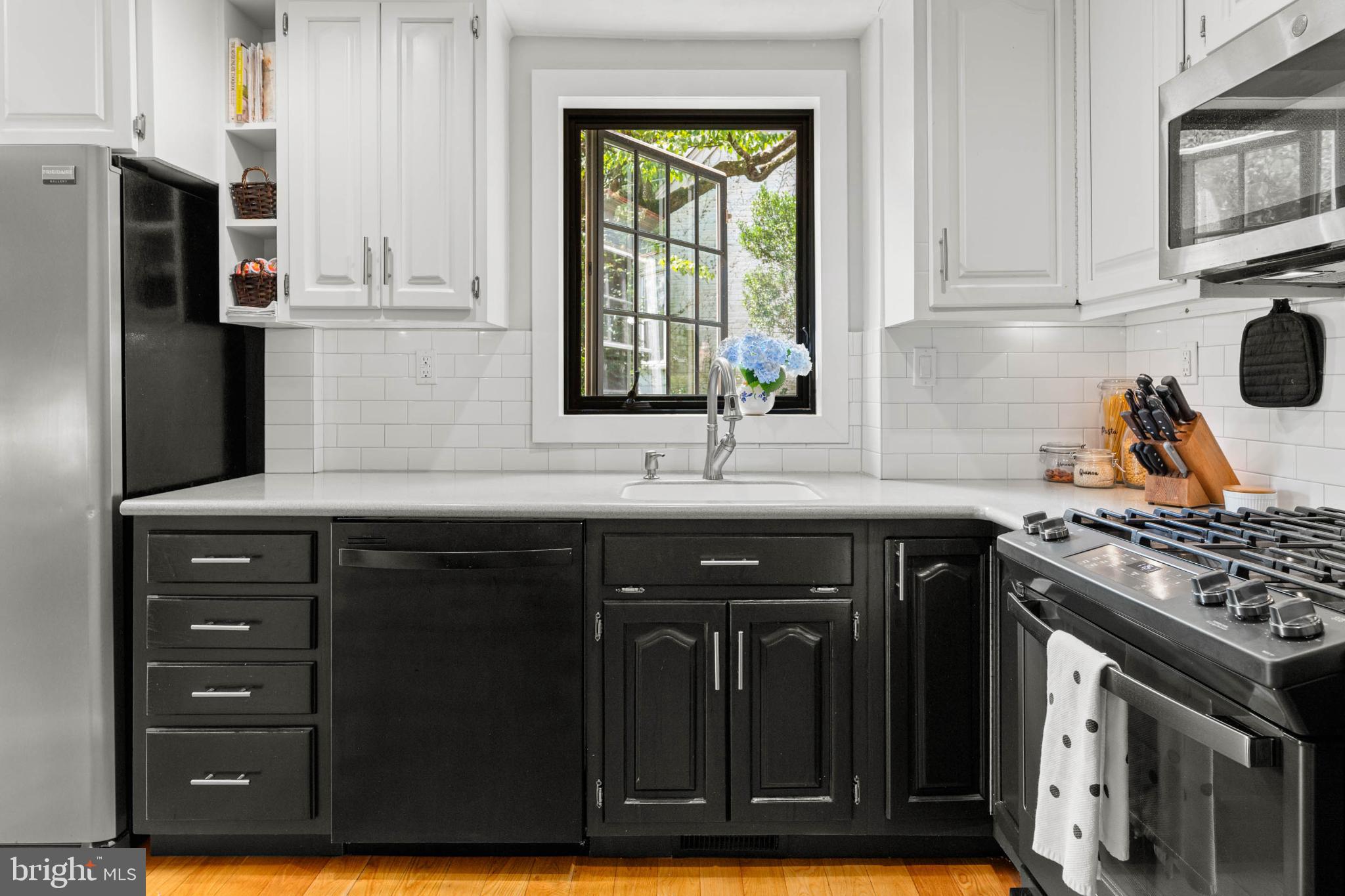 529 Covington Road Havertown, PA 19083 - Photo 13 of 34 a kitchen with stainless steel appliances granite countertop a stove a sink and a refrigerator with wooden cabinets