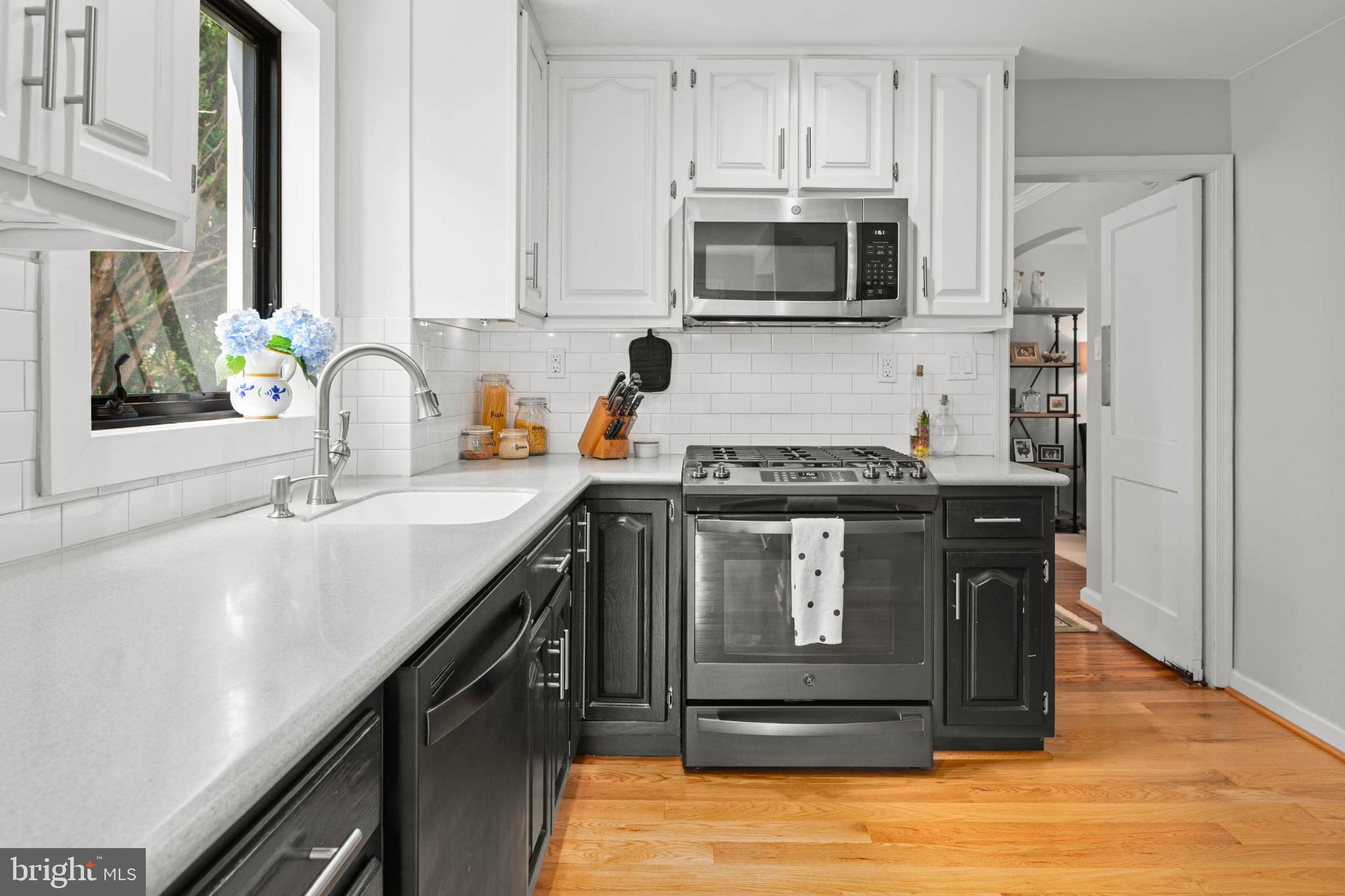 529 Covington Road Havertown, PA 19083 - Photo 14 of 34 a kitchen with stainless steel appliances granite countertop a stove a sink and a microwave