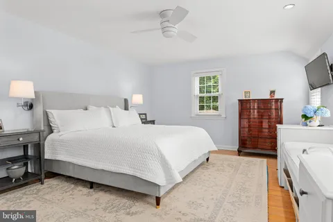 a bedroom with a bed dresser and a window