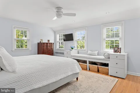 a bedroom with a large bed and a desk