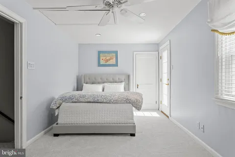 a spacious bedroom with a bed and a chandelier