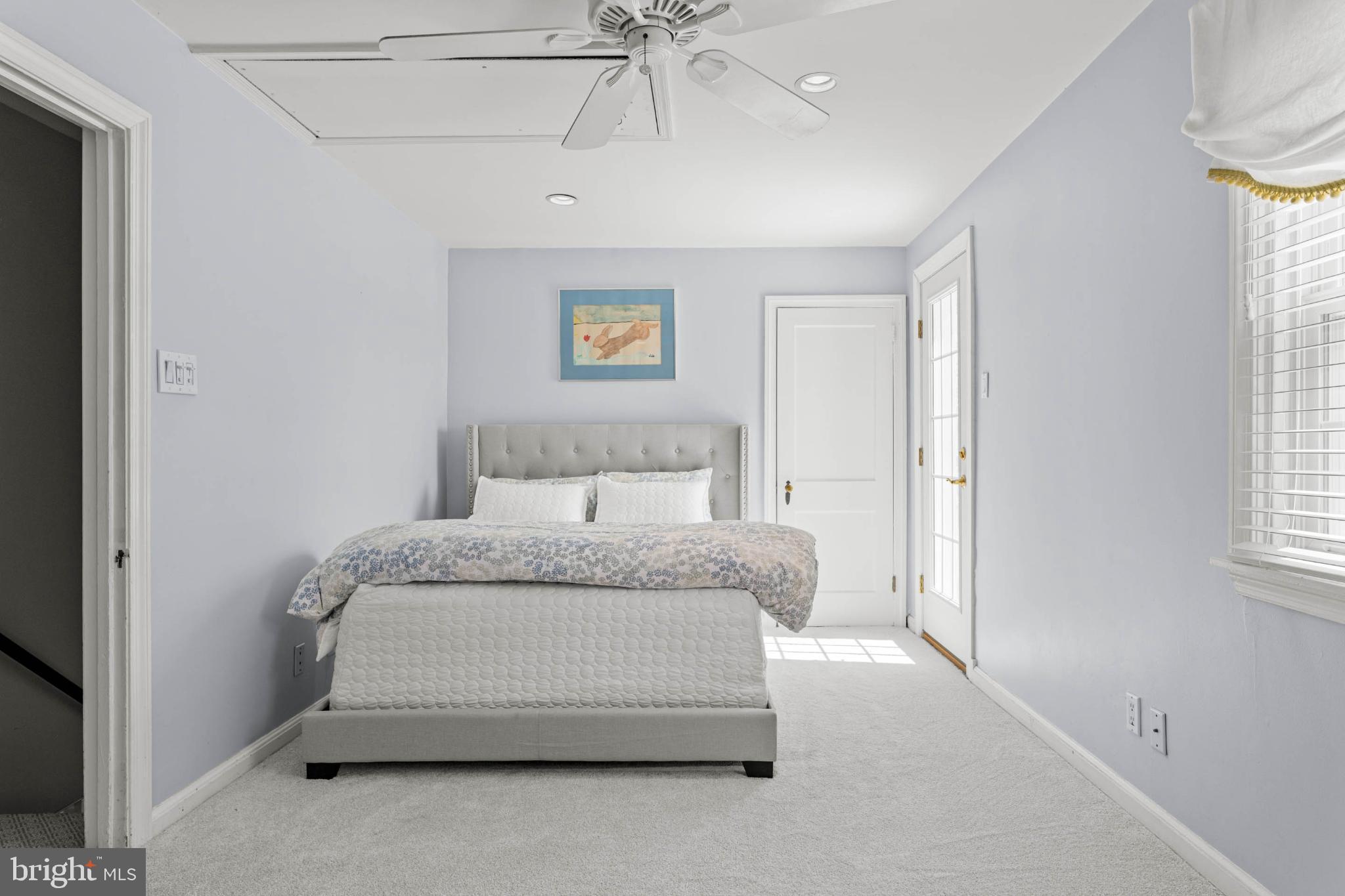 529 Covington Road Havertown, PA 19083 - Photo 20 of 34 a spacious bedroom with a bed and a chandelier