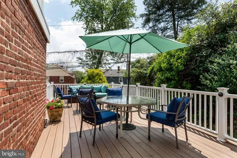 a view of balcony with chairs and wooden floor