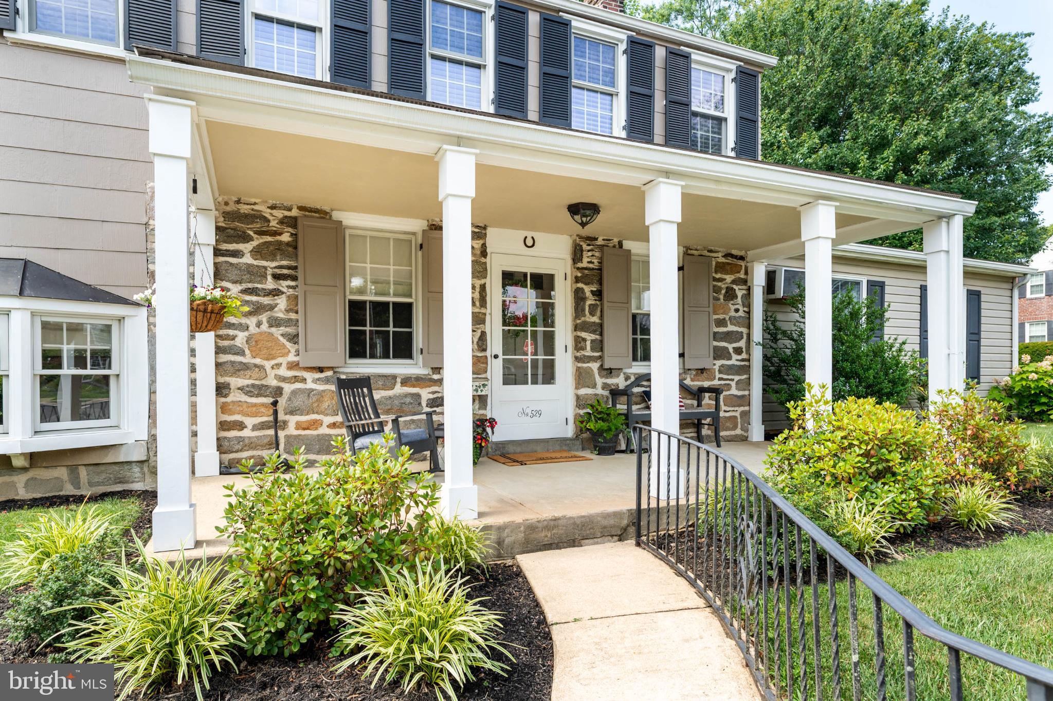 529 Covington Road Havertown, PA 19083 - Photo 4 of 34 front view of a brick house with a large window and potted plants