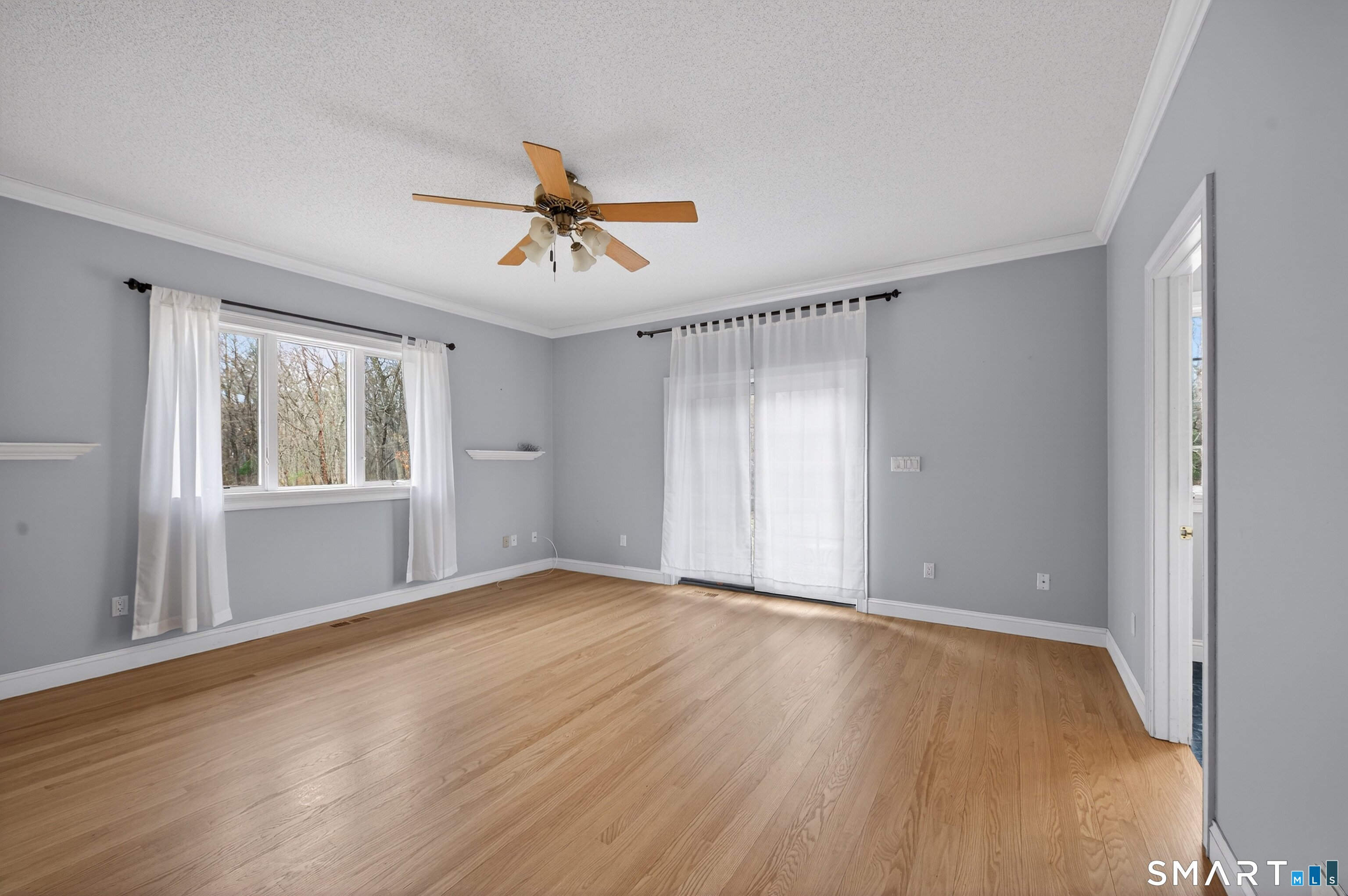 724 Strong Road South Windsor, CT 06074 - Photo 11 of 39 a view of an empty room with a window and wooden floor