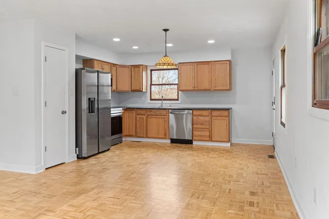 a view of a kitchen with a sink and a refrigerator