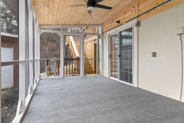 a view of a house with a yard covered in snow