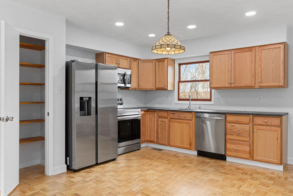 2883 Timber Ridge Buchanan, VA 24066 - Photo 3 of 39 a kitchen with stainless steel appliances granite countertop a refrigerator a sink dishwasher a stove with wooden cabinets and floor