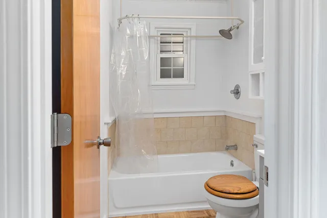 a bathroom with a toilet and a shower