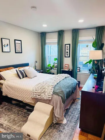 a bedroom with a large bed and a window