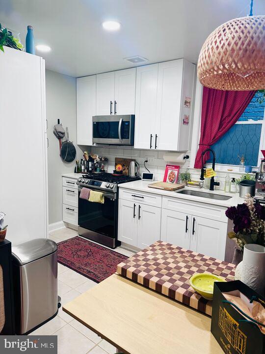 817 E Street Southeast, Unit 1 Washington, DC 20003 - Photo 18 of 25 a kitchen with stainless steel appliances a stove a sink dishwasher and cabinets