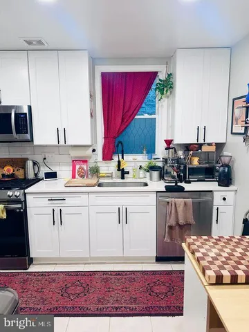 a kitchen with stainless steel appliances kitchen island granite countertop a sink dishwasher stove and cabinets